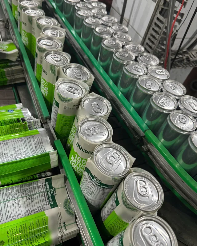 DQ Agri coconut water cans on the canning line