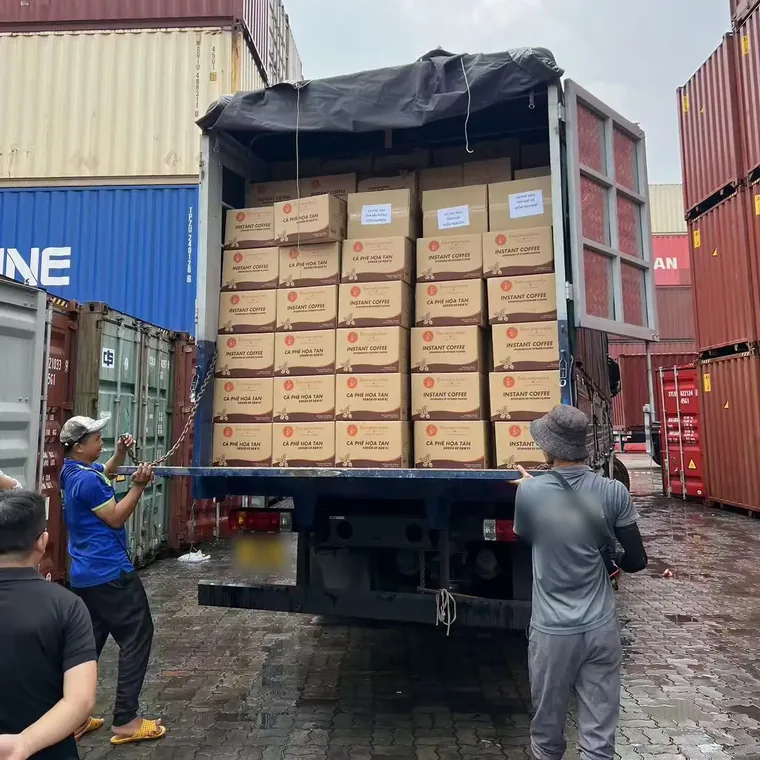 DQ cartons being loaded from a truck at the container yard